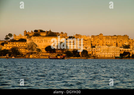 View of the City Palace, during a Boat Ride at Sunset, Lake Pichola, Udaipur, Rajasthan, India Stock Photo