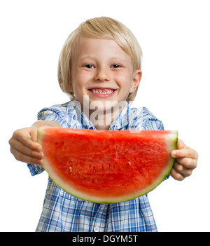 Close-up of cute happy smiling boy holding out a big juicy slice of watermelon. Isolated on white. Stock Photo