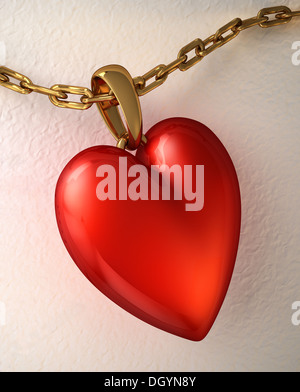 Red shiny heart pendant, with gold chain, placed on a white paper. Stock Photo