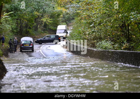Long Ashton, Bristol, UK. 28th Oct 2013 Clarken Coombe in Long Ashton Nr Bristol seen flooded a local cyclist and a lorry manage to get through flood waters following St. Jude Storm. The storm, called St Jude, brought the windiest weather to hit the UK since 1987 Credit:  Robert Timoney/Ģ����ý Live News Stock Photo