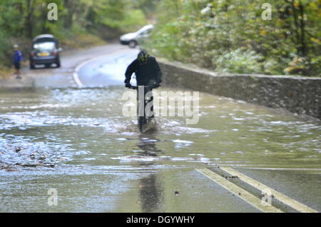Long Ashton, Bristol, UK. 28th Oct 2013 Clarken Coombe in Long Ashton Nr Bristol seen flooded a local cyclist and a lorry manage to get through flood waters following St. Jude Storm. The storm, called St Jude, brought the windiest weather to hit the UK since 1987 Credit:  Robert Timoney/Ģ����ý Live News Stock Photo