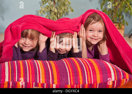 Girls, twins, six years, and three-year-old girl in the middle Stock Photo