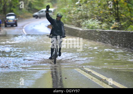 Long Ashton, Bristol, UK. 28th Oct 2013 Clarken Coombe in Long Ashton Nr Bristol seen flooded a local cyclist and a lorry manage to get through flood waters following St. Jude Storm. The storm, called St Jude, brought the windiest weather to hit the UK since 1987 Credit:  Robert Timoney/Ģ����ý Live News Stock Photo