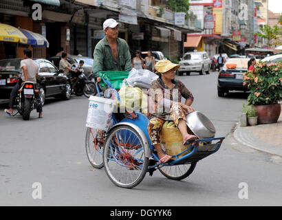 Couple on a tricycle, Phnom Penh, Cambodia, Southeast Asia, Asia Stock Photo