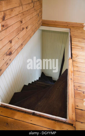 Trap door for wooden staircase leading to the downstairs floor of an old Canadiana cottage style residential home, 1826 Stock Photo