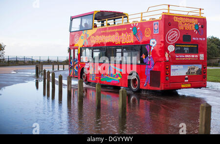 Bristol, UK 28th Oct 2013. A sight seeing bus passes through a flooded section of a road along Clifton Downs in Bristol following storms overnight and this morning. Gusts up to 99mph were recorded in the UK as the southern half of the country was hit by heavy storm weather. The Storm, called St Jude, brought the windiest weather to hit the UK since 1987. Credit:  Adam Gasson/Ģ����ý Live News Stock Photo