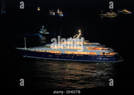 Motor yacht 'Laurel', built by shipyard 'Delta Marine', 73.15m in length, built in 2006, sailing out of Port Hercule at night Stock Photo