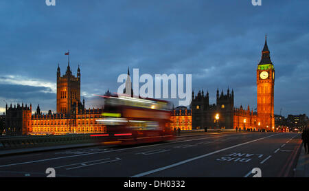 Westminster Bridge, Elizabeth Tower or Big Ben, Houses of Parliament, passing red double-decker bus in the evening Stock Photo