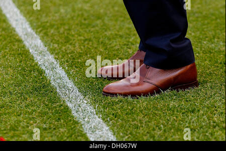 Manager, detail view of fine leather shoes, standing on the edge of a football pitch Stock Photo