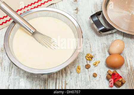 Ingredients for making pancake  batter. Batter making ingredients ready for making pancakes, on  wooden table. Viewed from above Stock Photo