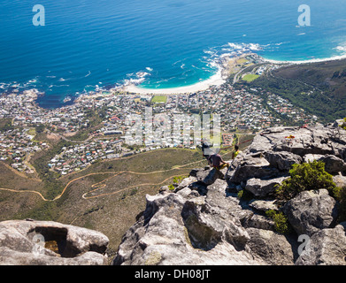 Cape Town from Table Mountain in South Africa - with people abseiling down the side Stock Photo