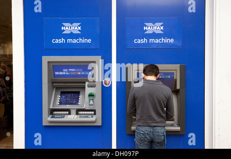 Halifax bank cash machines - man getting money, Norwich, Norfolk UK Stock Photo