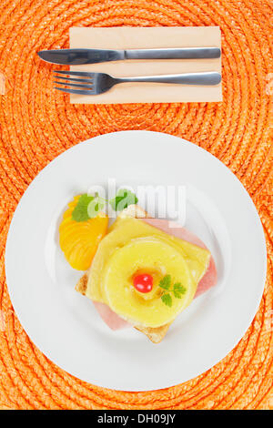 Toast 'Hawaii' with ham, pineapple, cheese, cocktail cherry and peach segments Stock Photo
