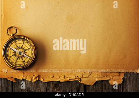 Antique brass compass over old background Stock Photo