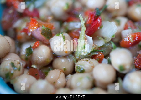 Chickpea salad with herbs and peppers in blue bowl