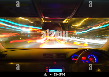 view through the windscreen of a moving car with motion blur and different sections on the motorway with road works cars lorries Stock Photo