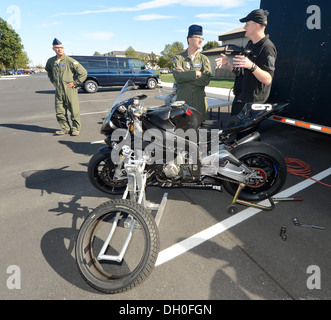 Tim Gooding (right), Army of Darkness motorcycle endurance racing team and mechanic, talks with Technical Sgt. David Grant, 3rd Stock Photo