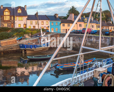 County Galway, Ireland: Morning light on harbor boats and village storefronts of the Connemara village of Roundstone Stock Photo