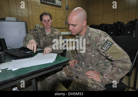 Staff Sgt. Megan Stockinger, 455th Air Expeditionary Wing NCO in charge of military justice, deployed from Little Rock Air Force Base, Ark., and a native of Geneva, Ala., provides legal assistance to Staff Sgt. Lowell Wann, 455 AEW chaplain assistant, dep Stock Photo