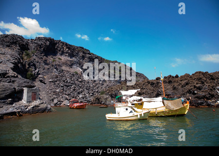 Boats that an elderly man lives on at the Hot Springs at the volcano Palea Kameni in Santorini, Greece on July 2, 2013. Stock Photo