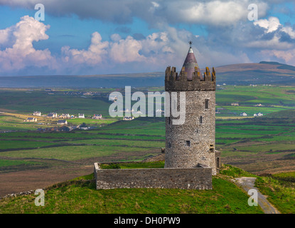 County Clare, Ireland: Round tower of Doonagore castle stands above the village of Doolin and the South Sound of Galway Bay Stock Photo