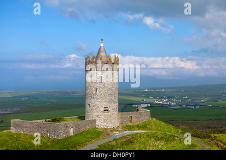 County Clare, Ireland: Round tower of Doonagore castle stands above the village of Doolin and the South Sound of Galway Bay Stock Photo