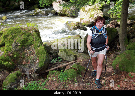 female walker with hiking sticks Stock Photo