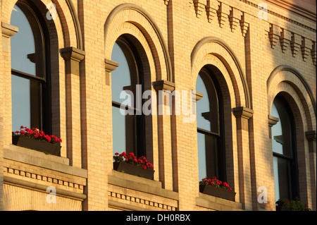 Geraniums on a windowsill of an old bank building in the Fairhaven historic district, city of Bellingham, Washington Stock Photo