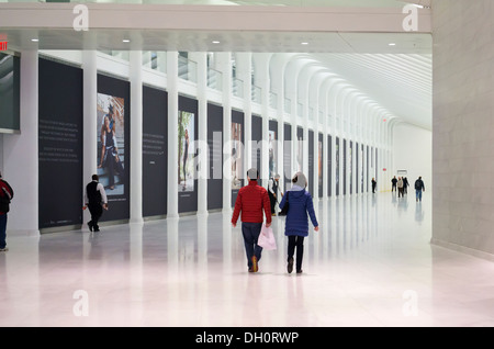 Commuters and tourists take in the marble-lined subterranean walkway connecting the World Trade Center PATH Station Stock Photo