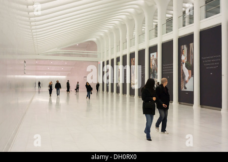 Commuters and tourists take in the marble-lined subterranean walkway connecting the World Trade Center PATH Station Stock Photo