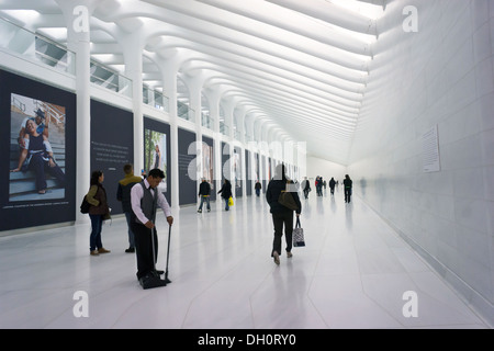 Commuters and tourists take in the marble-lined subterranean walkway connecting the World Trade Center PATH Station Stock Photo