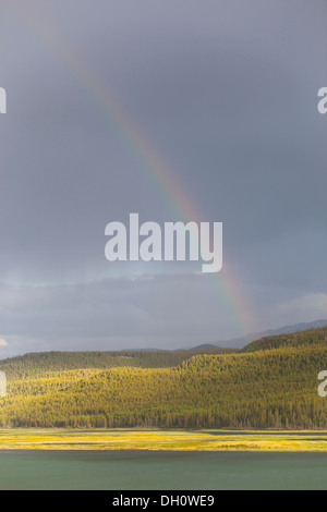 Heavy clouds and rainbow over Marsh Lake, headwaters of the Yukon River, near Whitehorse, Yukon Territory, Canada Stock Photo