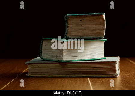 Three old stacked books Stock Photo