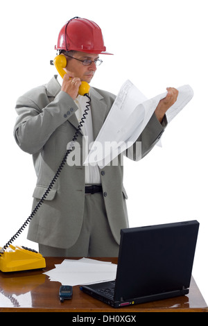 Construction engineer talking on phone about details of the project Stock Photo
