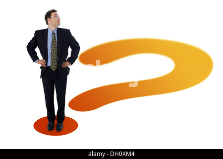 Business man standing on a big question mark's point Stock Photo