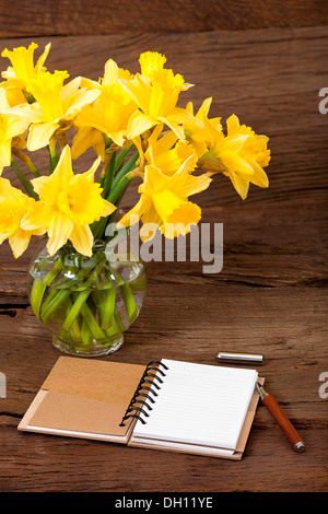 Note Pad opened with writable page and a Pen on old wooden Background Stock Photo