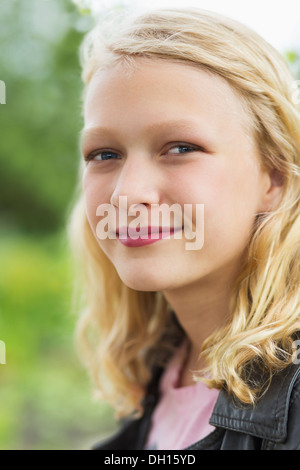 Caucasian girl smiling outdoors Stock Photo