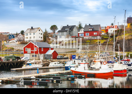 Small red and white fishing boats stand moored in Norway fishing town Rorvik Stock Photo