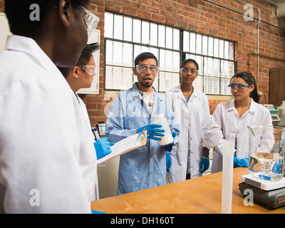 Students listening to teacher in science lab Stock Photo