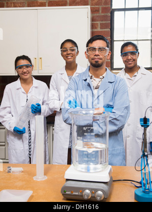 Teacher and students smiling in science lab Stock Photo