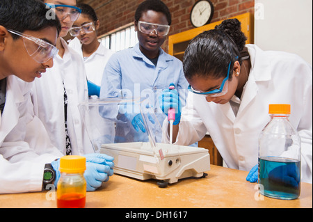 Teacher and students working in science lab Stock Photo