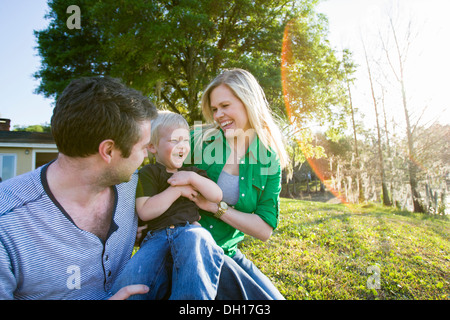 Caucasian family relaxing in backyard Stock Photo