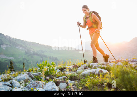 Caucasian woman hiking on rocky trail Stock Photo