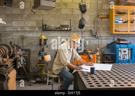 Middle Eastern man working in workshop Stock Photo