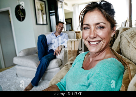 Caucasian couple relaxing in living room Stock Photo