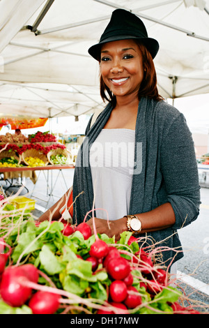 Black woman shopping at outdoor market Stock Photo