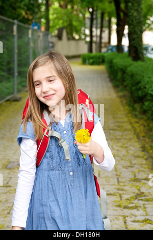 Little girl walking home from school, holding a flower, Munich, Bavaria, Germany Stock Photo