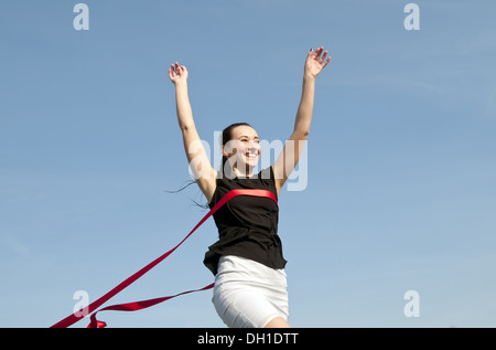 business woman crossing finishing line Stock Photo