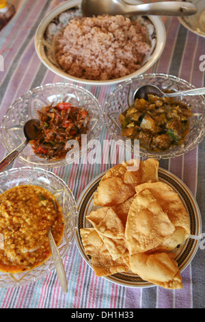 Traditional Sri Lankan rice curry dish with fresh poppadoms Stock Photo