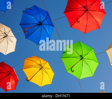 Multicolored umbrellas against the blue sky. Stock Photo